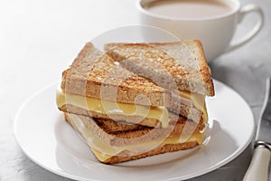 Grilled cheese sandwich of wholegrain bread with coffee for healthy breakfast.