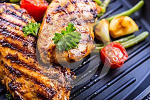 Grilled chicken breast in different variations with cherry tomat