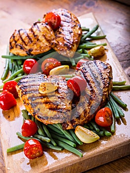 Grilled chicken breast in different variations with cherry tomat