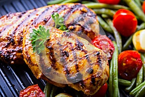 Grilled chicken breast in different variations with cherry tomat