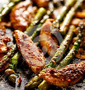Grilled chicken breast with green asparagus and capers photo