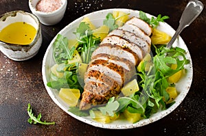 Grilled chicken breast with pineapple and arugula