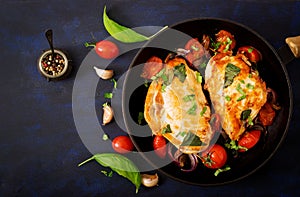 Grilled Chicken breast stuffed with tomatoes, garlic and basil in pan.