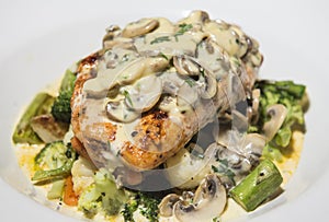 Grilled chicken breast and vegetables with creamy mushroom sauce