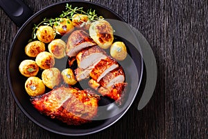 Grilled chicken breasts with browned new potatoes