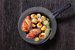 Grilled chicken breasts with browned new potatoes