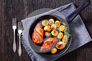 Grilled chicken breasts with browned new potatoes