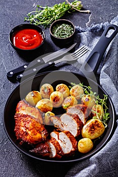 Grilled chicken breasts with browned new potatoes