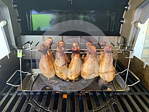 Grilled chicken drumsticks are cooked in gas grill