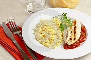 Grilled chicken escalope with tomato sauce and pasta