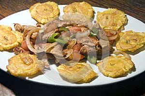 Grilled chicken fajita food with local tostones fried plantains photo