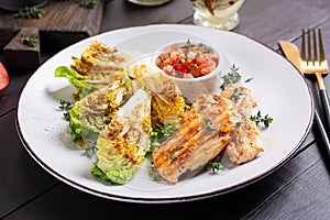 Grilled chicken fillet with mini romen and tomatoes salsa photo