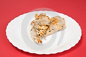 Grilled chicken fillet on white plate