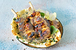 Grilled chicken kebabs chicken skewers with herbed garlic butter naan tortillas and Greek tzatziki sauce.