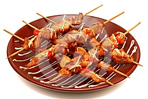 grilled chicken kebabs with sweet peppers in restaurant serving