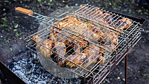 A grilled chicken leg on a barbecue racquet
