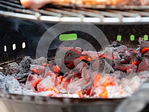 Grilled chicken legs on the flaming barbeque grill