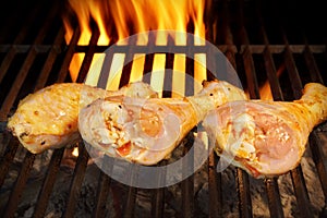 Grilled chicken legs on the flaming grill