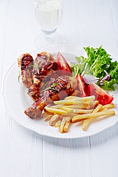 Grilled Chicken Legs with French Fries and Salad