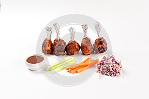 Grilled chicken legs with lettuce, carrot, sauce, onion and lettuce