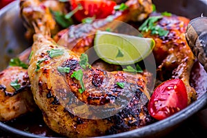 Grilled chicken legs, lettuce and cherry tomatoes limet olives. Traditional cuisine. Mediterranean cuisine