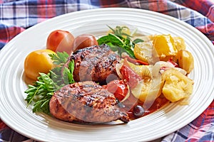 Grilled chicken Legs with potato and herbs on a plate