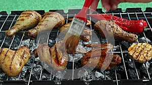 Grilled chicken legs wings barbecue griller cooking process Grease with marinade