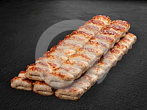 Grilled chicken lulas. Ground meat product. Grill menu. Isolated on a dark background photo