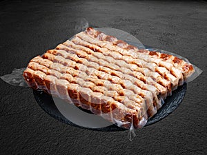 Grilled chicken lulas. Vacuum-packed minced meat products. Isolated on a dark background photo