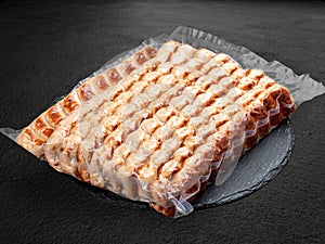 Grilled chicken lulas. Vacuum-packed minced meat products. Isolated on a dark background photo