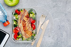 Grilled chicken meal prep containers with rice, broccoli and tomatoes