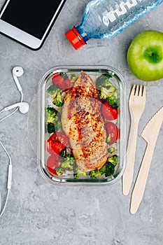 Grilled chicken meal prep containers with rice, broccoli and tomatoes