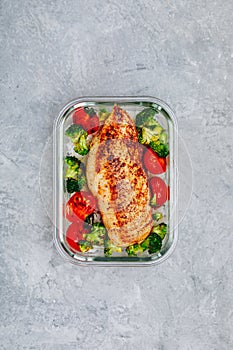 Grilled chicken meal prep containers with rice, broccoli and tomatoes
