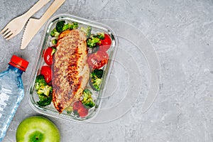 Grilled chicken meal prep containers with rice, broccoli and tomatoes