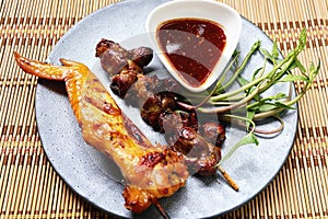 Grilled chicken offal and chicken grilled on plate.