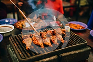 Grilled chicken and pork in local restaurant in Vang Vieng