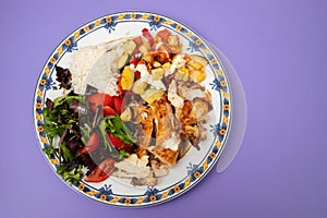 grilled chicken with salad and boiled rice in plate