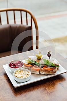 Grilled chicken sandwich made with homemade bread, tomato and lettuce served with beetroot salad and coleslaw