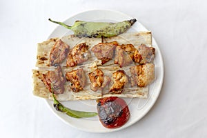 Grilled chicken shish kebab in white plate