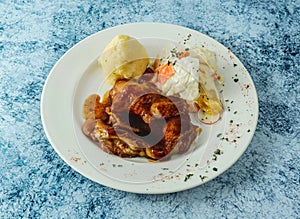 grilled Chicken steak with mashed potato and egg served in plate isolated on background top view of italian food