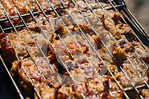 Grilled chicken thigh on the flaming grill