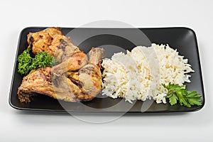 Grilled chicken thigh with rice and parsley