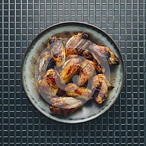 Grilled Chicken Wings Appetizing Display on Metal Grid Background