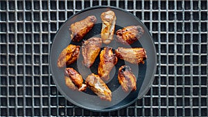 Grilled Chicken Wings Appetizing Display on Metal Grid Background