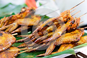 Grilled Chicken Wings on banana leaf, Thai style food. Thai traditional menu - Thai street food.