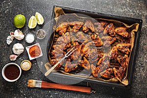 Grilled chicken wings in barbecue sauce in baking tray