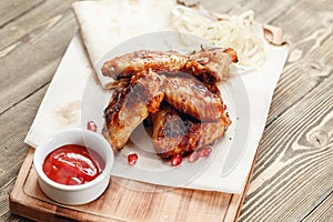 Grilled chicken wings. Serving on a wooden Board on a rustic table. Barbecue restaurant menu, a series of photos of