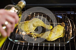 Grilled chickenleg in oven sprinkle withe olive oil