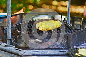 Grilled corn on the cob with butter and salt on the grill plate