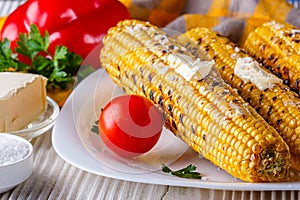 Grilled corn cob on white wooden rustic background